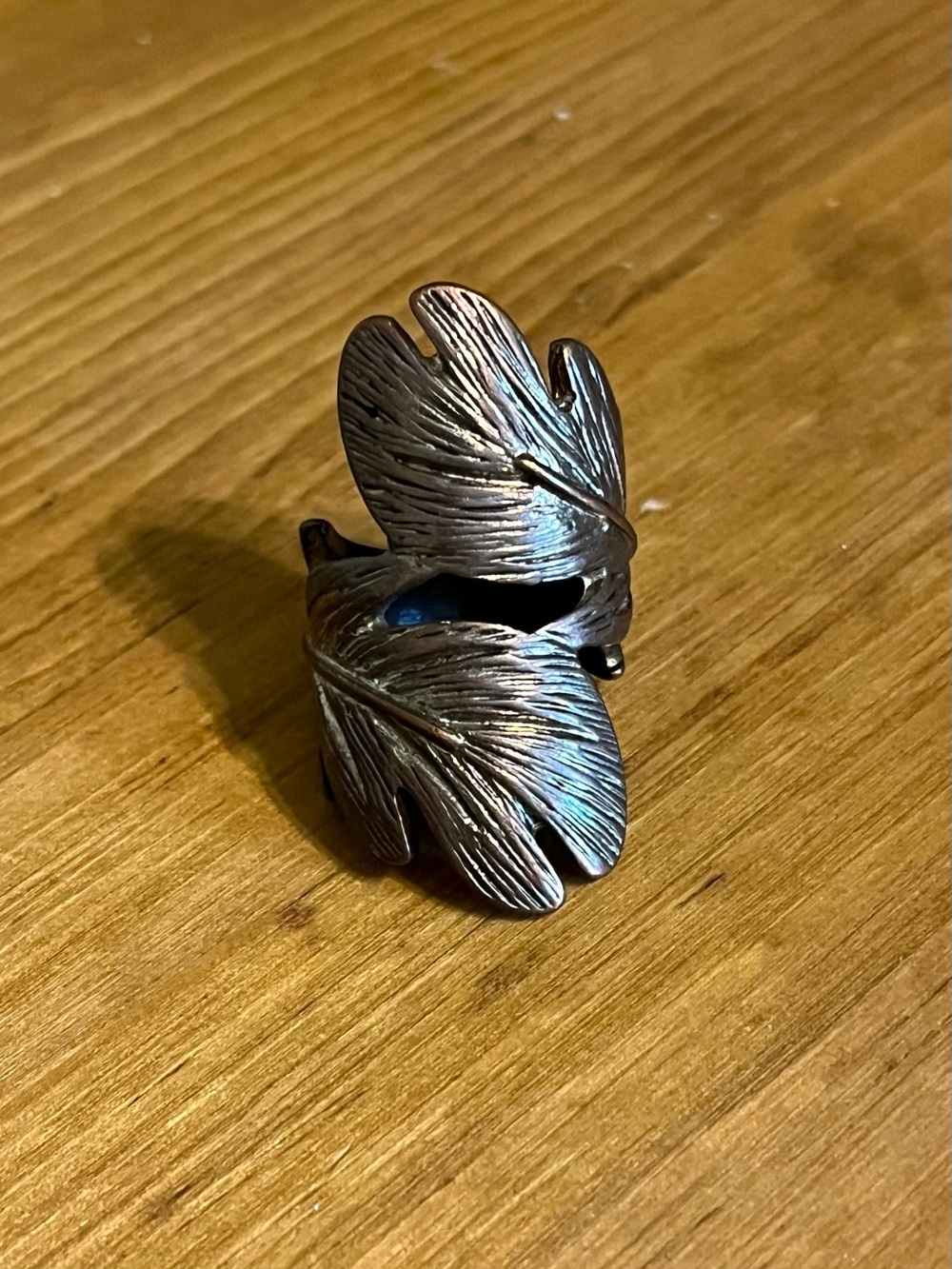 Boho band with metallic shiny finish of stacked feather size 5 1/2 & 1 1/2” long